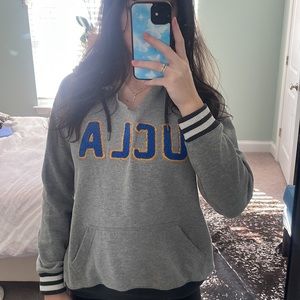 Gray UCLA varsity hoodie with v cut and sleeve details